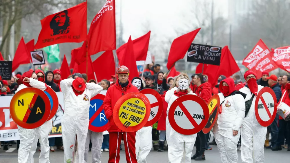 Protesting workers and trade union members hold flags and signs during a national strike demanding stronger public services in Brussels, Belgium February 13, 2025. REUTERS/Stephanie Lecocq