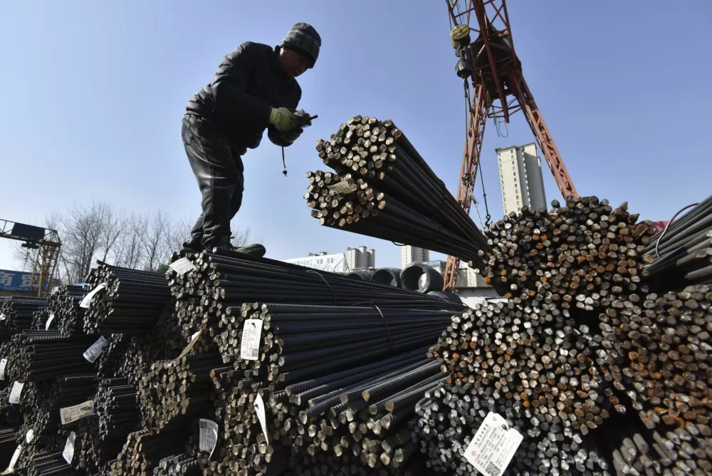 A worker labors at a steel market in Fuyang city in central China's Anhui province Monday, Feb. 10, 2025. (Chinatopix Via AP)