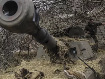 FILE - In this photo provided by Ukraine's 24th Mechanized Brigade press service, a soldier prepares to fire a howitzer towards Russian positions on the front line near Chasiv Yar, Donetsk region, Ukraine, Friday, Feb. 7, 2025. (Oleg Petrasiuk/Ukraine's 24th Mechanized Brigade via AP, File)