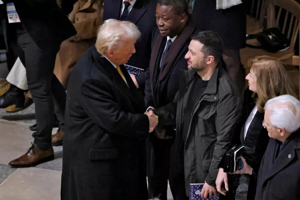 FILE PHOTO: U.S. President-elect Donald Trump and Ukrainian President Volodymyr Zelenskiy shake hands inside the Notre-Dame de Paris Cathedral ahead of a ceremony to mark its re-opening following the 2019 fire, in Paris, France, December 7, 2024. LUDOVIC MARIN/Pool via REUTERS/File Photo