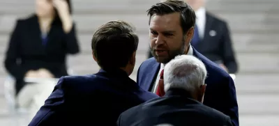 U.S. Vice President JD Vance greets French President Emmanuel Macron and Indian Prime Minister Narendra Modi after delivering a speech during the plenary session of the Artificial Intelligence (AI) Action Summit at the Grand Palais in Paris, France, February 11, 2025. REUTERS/Benoit Tessier