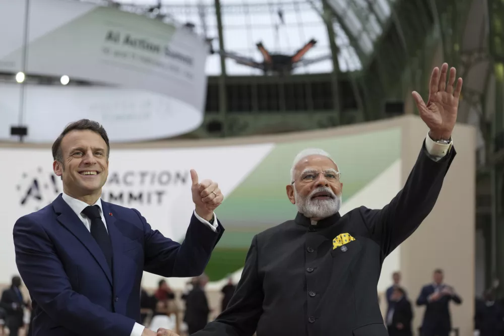 French President Emmanuel Macron, center left, poses with India's Prime Minister Narendra Modi at the Grand Palais during the Artificial Intelligence Action Summit in Paris, Tuesday, Feb. 11, 2025. (AP Photo/Aurelien Morissard)