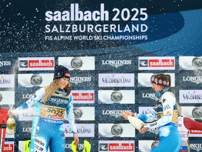 Alpine Skiing - FIS Alpine World Ski Championships - Women's Team Combined - Saalbach, Austria - February 11, 2025 Mikaela Shiffrin and Breezy Johnson of the U.S. celebrate on the podium after winning REUTERS/Lisi Niesner