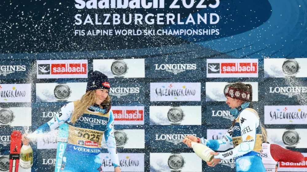 Alpine Skiing - FIS Alpine World Ski Championships - Women's Team Combined - Saalbach, Austria - February 11, 2025 Mikaela Shiffrin and Breezy Johnson of the U.S. celebrate on the podium after winning REUTERS/Lisi Niesner