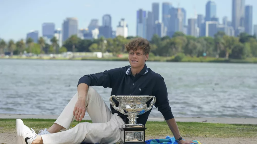 Jannik Sinner of Italy poses with Norman Brookes Challenge Cup the morning after defeating Alexander Zverev of Germany in the men's singles final at the Australian Open tennis championship in Melbourne, Australia, Monday, Jan. 27, 2025. (AP Photo/Mark Baker)