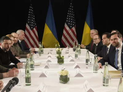 Ukraine's President Volodymyr Zelenskyy, left, and United States Vice-President JD Vance, right, pose during a meeting on the sidelines of the Munich Security Conference in Munich, Germany, Friday, Feb. 14, 2025. (AP Photo/Matthias Schrader)