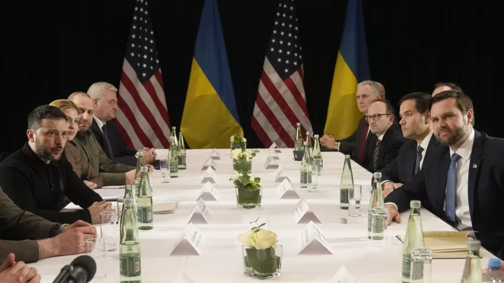 Ukraine's President Volodymyr Zelenskyy, left, and United States Vice-President JD Vance, right, pose during a meeting on the sidelines of the Munich Security Conference in Munich, Germany, Friday, Feb. 14, 2025. (AP Photo/Matthias Schrader)