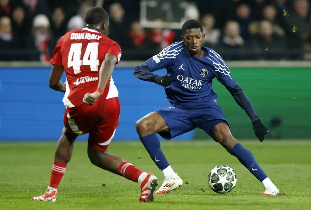 Soccer Football - Champions League - Knockout Phase Playoff - First Leg - Brest v Paris St Germain - Stade de Roudourou, Guingamp, France - February 11, 2025 Paris St Germain's Ousmane Dembele in action with Brest's Soumaila Coulibaly REUTERS/Stephane Mahe