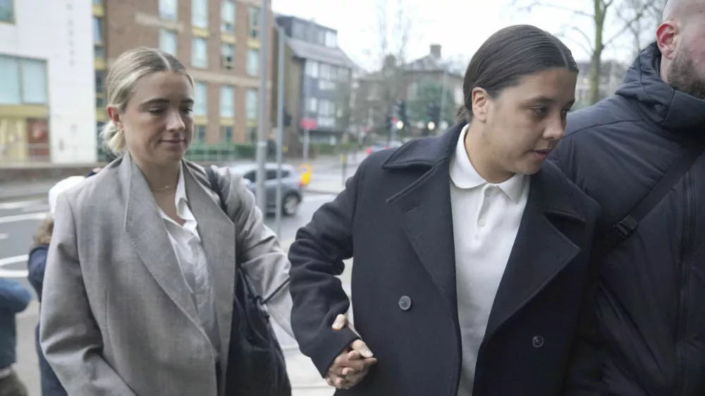 Chelsea and Australia soccer player Sam Kerr, right, arrives wither partner Kristie Mewis at Kingston Crown Court, south west London, Monday, Feb. 10, 2025, where she is charged with alleged racially aggravated harassment of a police officer. (Jonathan Brady/PA via AP)