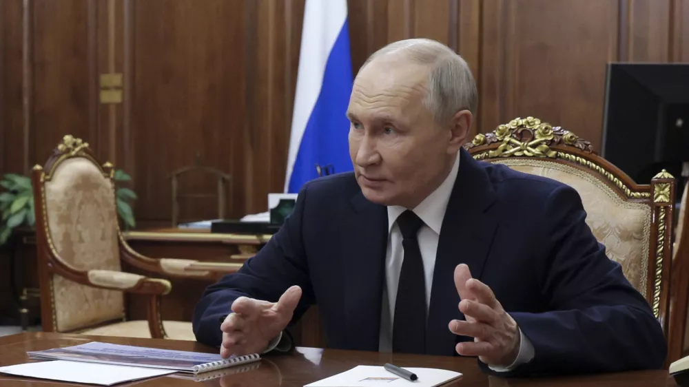 Russian President Vladimir Putin gestures while speaking to the head of the Russian-controlled Donetsk region of Ukraine Denis Pushilin, at the Kremlin in Moscow, Russia, Monday, Feb. 10, 2025. (Gavriil Grigorov, Sputnik, Kremlin Pool Photo via AP)