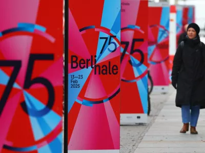 A pedestrian walks past advertising posters for the upcoming 75th Berlinale International Film Festival in Berlin, Germany February 12, 2025. REUTERS/Fabrizio Bensch