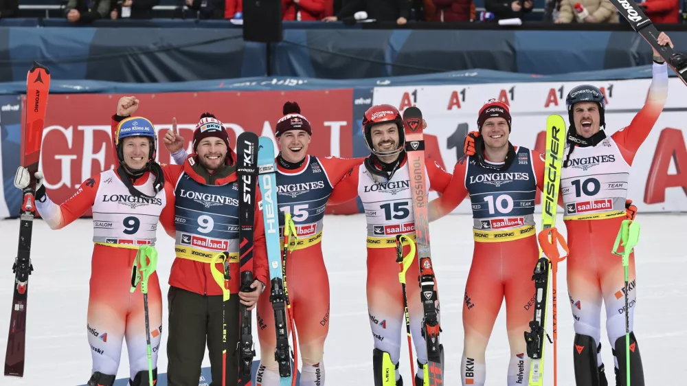 Switzerland's Loic Meillard, third from right, and teammate Franjo von Allmen, third from left, celebrate winning the gold medal in a men's team combined event, with silver medalists Switzerland's Nef Tanguy, left, and teammate Alexis Monney, second from left, and bronze medalists Switzerland's Stefan Rogentin, second from right, and teammate Marc Rochat, at the Alpine Ski World Championships, in Saalbach-Hinterglemm, Austria, Wednesday, Feb. 12, 2025. (AP Photo/Marco Trovati)