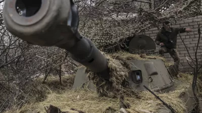 FILE - In this photo provided by Ukraine's 24th Mechanized Brigade press service, a soldier prepares to fire a howitzer towards Russian positions on the front line near Chasiv Yar, Donetsk region, Ukraine, Friday, Feb. 7, 2025. (Oleg Petrasiuk/Ukraine's 24th Mechanized Brigade via AP, File)