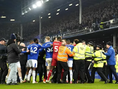 Liverpool and Everton players tussle following the final whistle in a Premier League soccer match at Goodison Park, Wednesday, Feb. 12, 2025, in Liverpool. (Nick Potts/PA via AP)