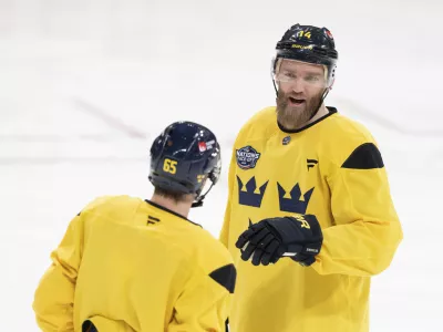 Sweden's Mattias Ekholm (14) and Erik Karlsson (65) talk during practice for the 4 Nations Face-Off hockey tournament in Montreal, Tuesday, Feb. 11, 2025. (Christinne Muschi/The Canadian Press via AP)