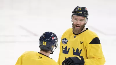 Sweden's Mattias Ekholm (14) and Erik Karlsson (65) talk during practice for the 4 Nations Face-Off hockey tournament in Montreal, Tuesday, Feb. 11, 2025. (Christinne Muschi/The Canadian Press via AP)