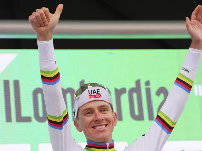 Reigning World Champion Slovenia's Tadej Pogacar celebrates winning Il Lombardia, Tour of Lombardy cycling race, in Como, Italy, Saturday, Oct. 12, 2024. (Spada/LaPresse via AP)