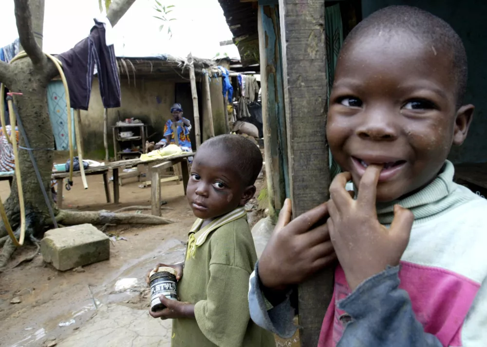 Slum children stand in a yard of a shanty town of Adjame in Abidjan July 04, 2005. More than 40 percent of Africans live on less than $1 a day, 200 million Africans are threatened by serious food shortages and AIDS kills more than 2 million Africans a year. Rock stars around the world sang for Africa on Saturday to try to pressure the G8 leaders into action. The G8 summit on Wednesday and Thursday will be chaired by British Prime Minister Tony Blair, who has put Africa at the top of the agenda. Reuters/Luc Gnago