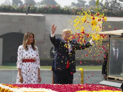 FILE - U.S. President Donald Trump offers floral respects, with first lady Melania Trump standing beside him, at Raj Ghat, the memorial for Mahatma Gandhi, in New Delhi, India, Feb. 25, 2020. (AP Photo/Alex Brandon, File)