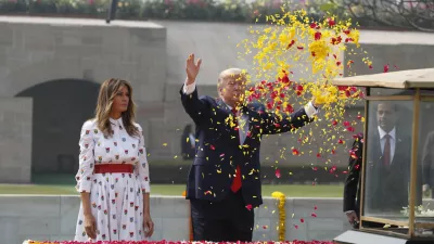 FILE - U.S. President Donald Trump offers floral respects, with first lady Melania Trump standing beside him, at Raj Ghat, the memorial for Mahatma Gandhi, in New Delhi, India, Feb. 25, 2020. (AP Photo/Alex Brandon, File)