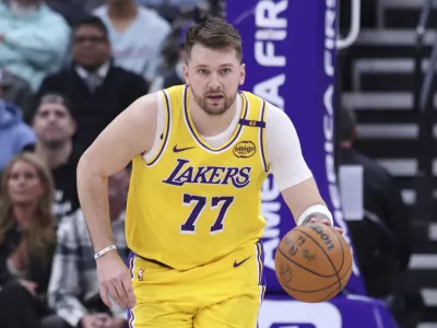 Los Angeles Lakers guard Luka Doncic brings the ball up the court against the Utah Jazz during the first half of an NBA basketball game, Wednesday, Feb. 12, 2025, in Salt Lake City. (AP Photo/Rob Gray)