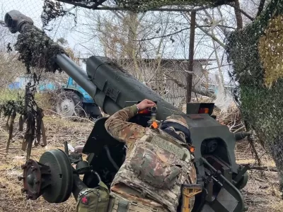 FILE - In this photo taken from a video released by Russian Defense Ministry press service on Nov. 29, 2024, a Russian serviceman aims a D-30 howitzer towards Ukrainian positions in the border area of Kursk region, Russia. (Russian Defense Ministry Press Service via AP, File)