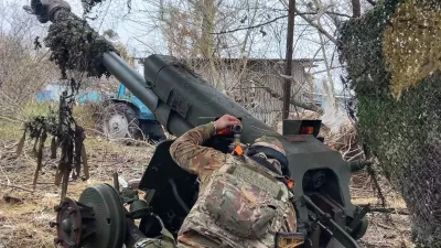 FILE - In this photo taken from a video released by Russian Defense Ministry press service on Nov. 29, 2024, a Russian serviceman aims a D-30 howitzer towards Ukrainian positions in the border area of Kursk region, Russia. (Russian Defense Ministry Press Service via AP, File)