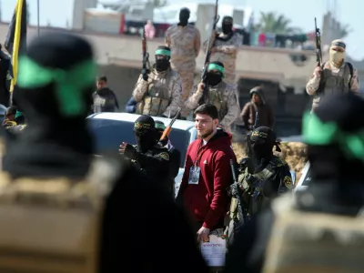 Russian-Israeli Sasha (Alexandre) Troufanov, a hostage held in Gaza since the deadly October 7, 2023 attack, is escorted by Palestinian Hamas militants and Islamic Jihad militants as part of a ceasefire and a hostages-prisoners swap deal between Hamas and Israel in Khan Younis, in the southern Gaza Strip, February 15, 2025. REUTERS/Hatem Khaled  REFILE - CORRECTING ID FROM "U.S.-ISRAELI SAGUI DEKEL-CHEN" TO "RUSSIAN-ISRAELI SASHA (ALEXANDRE) TROUFANOV".