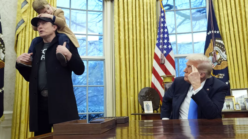 President Donald Trump listens as Elon Musk, joined by his son X Æ A-Xii, speaks in the Oval Office at the White House, Tuesday, Feb. 11, 2025, in Washington. (Photo/Alex Brandon)