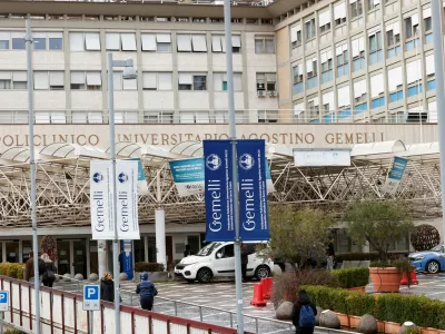 People walk outside the Gemelli Hospital where Pope Francis is hospitalised for bronchitis treatment in Rome, Italy, February 15, 2025. REUTERS/Ciro De Luca