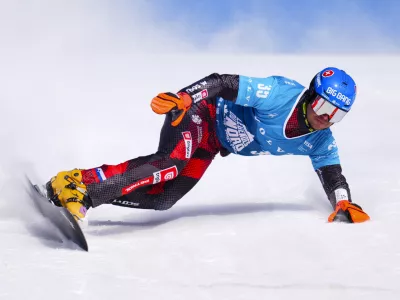 Slovakian Zan Kosir races in qualification round of the men's parallel slalom FIS Snowboard Alpine World Cup at Val Saint-Come in Saint-Come, Quebec, Canada, on Saturday, Feb. 15, 2025. (Sean Kilpatrick/The Canadian Press via AP)