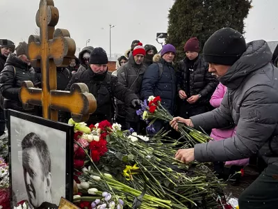 People lay flowers at the grave of Russian opposition leader Alexei Navalny, a year after his death, at the Borisovskoye Cemetery in Moscow, on Sunday, Feb. 16, 2025. (AP Photo)