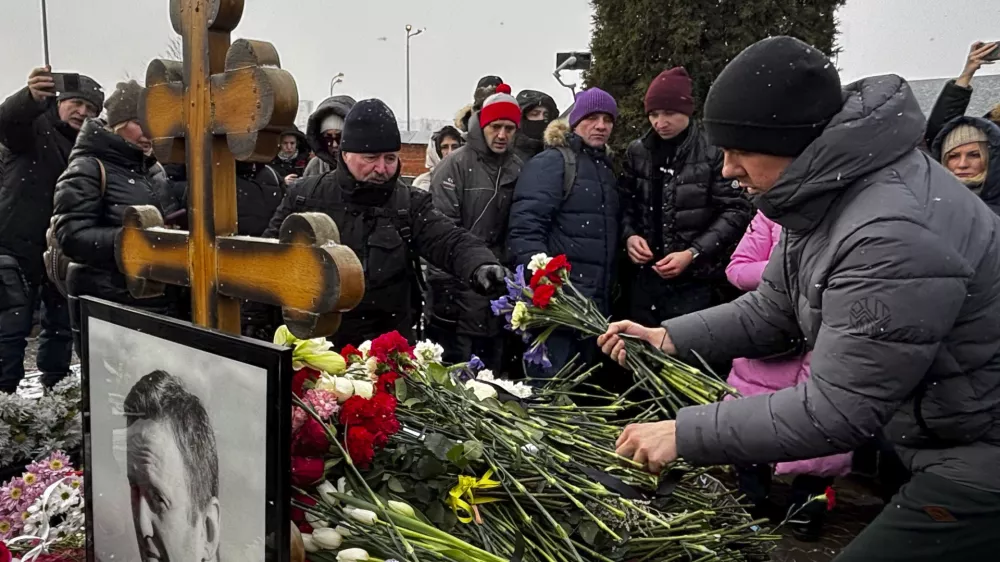 People lay flowers at the grave of Russian opposition leader Alexei Navalny, a year after his death, at the Borisovskoye Cemetery in Moscow, on Sunday, Feb. 16, 2025. (AP Photo)