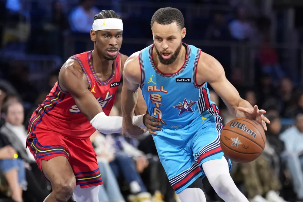 Feb 16, 2025; San Francisco, CA, USA; Shaq's OGs guard Stephen Curry (30) of the Golden State Warriors controls the ball against Chuck's Global Stars guard Shai Gilgeous-Alexander (2) of the Oklahoma City Thunder during the 2025 NBA All Star Game at Chase Center. Mandatory Credit: Kyle Terada-Imagn Images