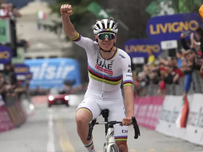 Reigning World Champion Slovenia's Tadej Pogacar celebrates winning Il Lombardia, Tour of Lombardy cycling race, in Como, Italy, Saturday, Oct. 12, 2024. (Gian Mattia D'Alberto/LaPresse via AP)