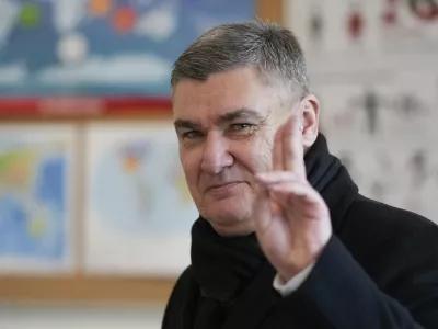 Croatia's President Zoran Milanovic greets the media after his vote during a presidential election at a polling station in Zagreb, Croatia, Sunday, Dec. 29, 2024. (AP Photo/Darko Bandic)