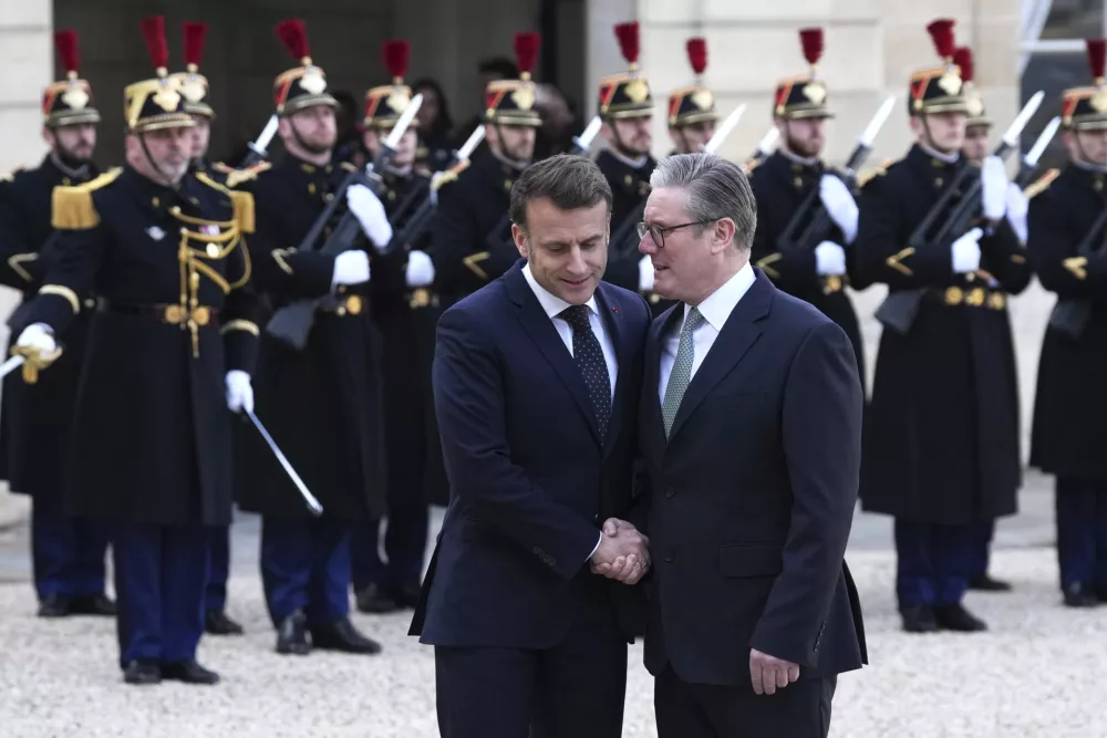 French President Emmanuel Macron, left, greets Britain's Prime Minister Keir Starmer as he arrives for an informal meeting of leaders from key European Union nations and the United Kingdom at the Elysee Palace in Paris, Monday, Feb. 17, 2025. (AP Photo/Aurelien Morissard)