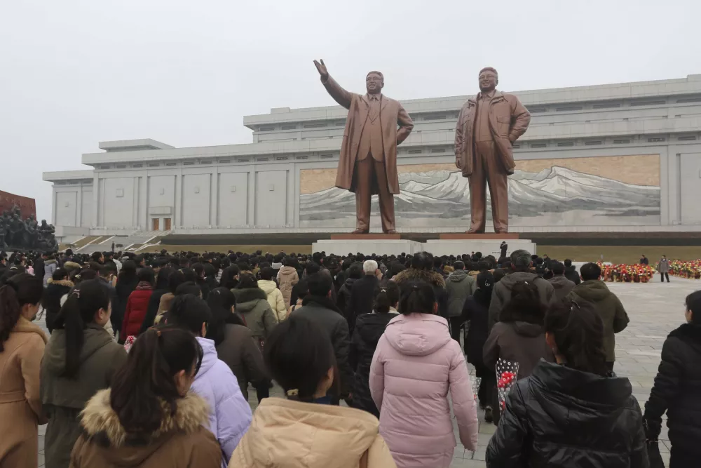 People pay respect to the statues of former leaders Kim Il Sung and Kim Jong Il on Mansu Hill on the occasion of the 83rd anniversary of the birth of its late leader Kim Jong Il, in Pyongyang, North Korea, Sunday, Feb. 16, 2025. (AP Photo/Cha Song Ho)