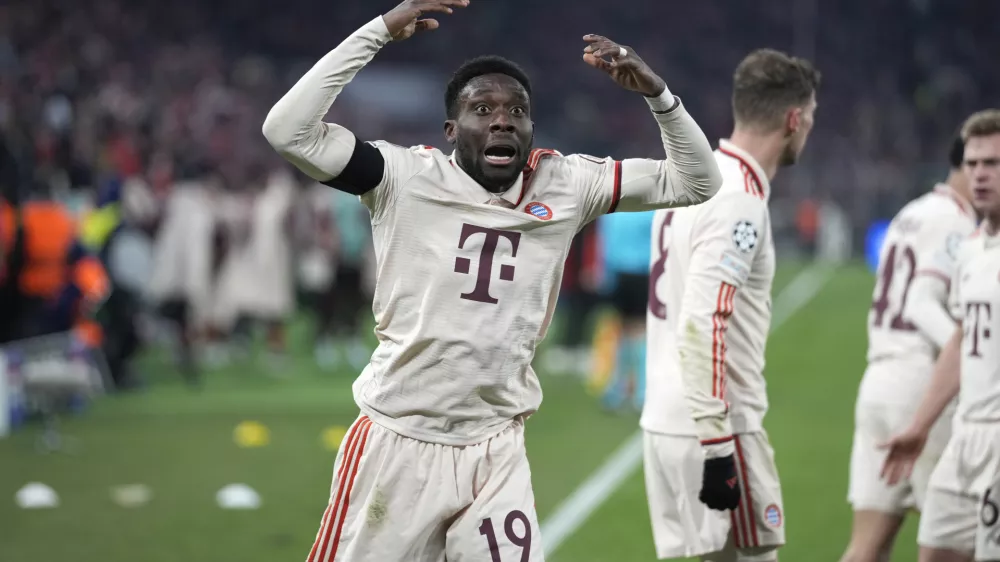 Bayern's Alphonso Davies, centre, celebrates after scoring his side's opening goal during the Champions League playoff second leg soccer match between FC Bayern Munich and Celtic Glasgow at the Allianz Arena in Munich, Germany, Tuesday, Feb. 18, 2025. (AP Photo/Matthias Schrader)