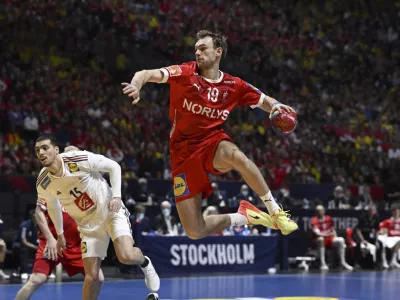 France's Mathieu Grebille and Denmark's Mathias Gidsel during the IHF Men's World Championship handball final match between France and Denmark at Tele2 Arena, Stockholm, Sweden, Sunday Jan. 29, 2023. (Jessica Gow/TT News Agency via AP)