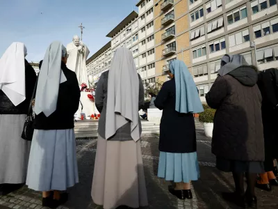 Nuns pray outside the Gemelli Hospital where Pope Francis is admitted for treatment, in Rome, Italy, February 23, 2025. REUTERS/Vincenzo Livieri