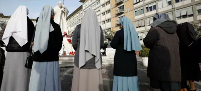 Nuns pray outside the Gemelli Hospital where Pope Francis is admitted for treatment, in Rome, Italy, February 23, 2025. REUTERS/Vincenzo Livieri