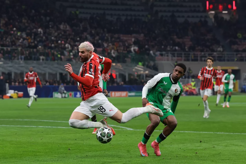 18 February 2025, Italy, Milan: Milan's Theo Hernandez and Feyenoord's Givairo Read battle for the ball during the UEFA Champions League layoff second leg soccer match between AC Milan and Feyenoord at the San Siro stadium. Photo: Jonathan Moscrop/CSM via ZUMA Press Wire/dpa