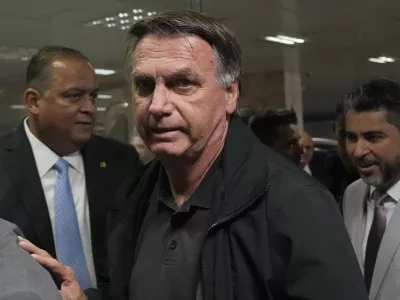 Former Brazilian President Jair Bolsonaro arrives for a luncheon with senators from his support base, at the National Congress building in Brasilia, Brazil, Tuesday, Feb. 18, 2025. (AP Photo/Eraldo Peres)