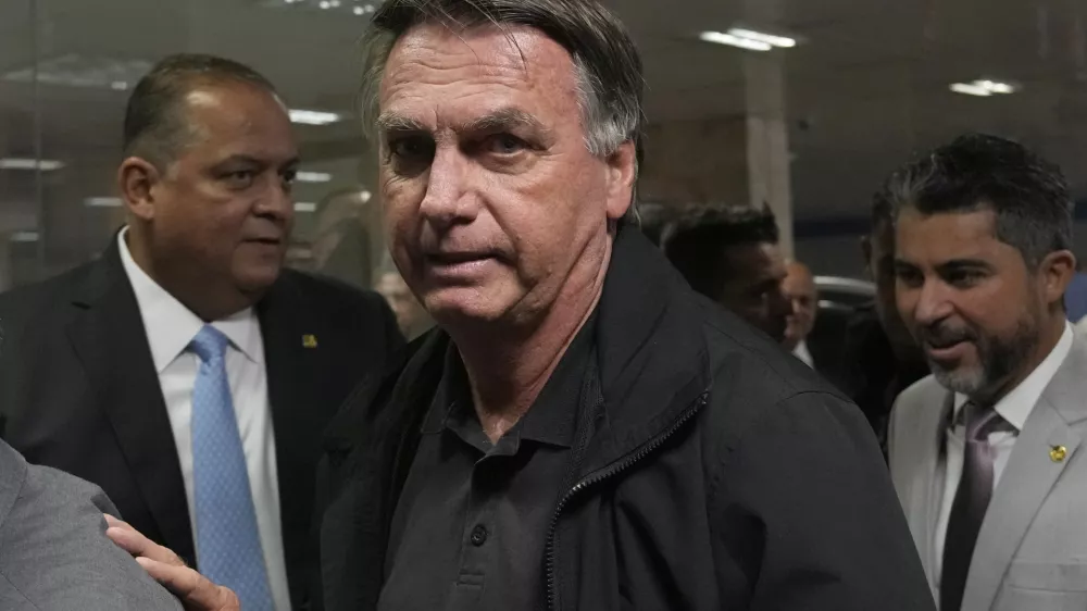 Former Brazilian President Jair Bolsonaro arrives for a luncheon with senators from his support base, at the National Congress building in Brasilia, Brazil, Tuesday, Feb. 18, 2025. (AP Photo/Eraldo Peres)