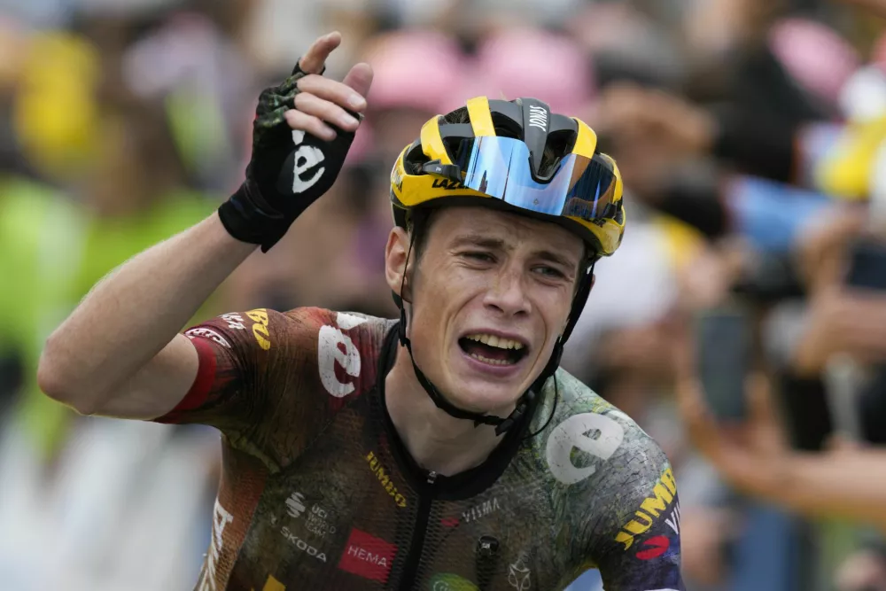 Stage winner and new overall leader Denmark's Jonas Vingegaard celebrates as he crosses the finish line during the eleventh stage of the Tour de France cycling race over 152 kilometers (94.4 miles) with start in Albertville and finish in Col du Granon Serre Chevalier, France, Wednesday, July 13, 2022. (AP Photo/Daniel Cole)