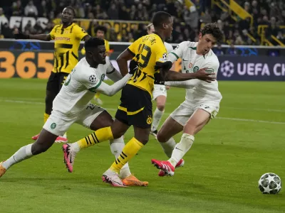 Sporting's Ousmane Diomande, left, and Eduardo Quaresma hold Dortmund's Jamie Bynoe-Gittens during the Champions League playoff second leg soccer match between Borussia Dortmund and Sporting CP at the Signa-Iduna Park in Dortmund, Germany, Wednesday, Feb. 19, 2025. (AP Photo/Martin Meissner)