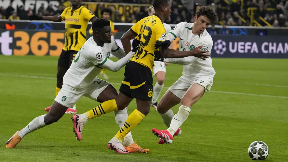 Sporting's Ousmane Diomande, left, and Eduardo Quaresma hold Dortmund's Jamie Bynoe-Gittens during the Champions League playoff second leg soccer match between Borussia Dortmund and Sporting CP at the Signa-Iduna Park in Dortmund, Germany, Wednesday, Feb. 19, 2025. (AP Photo/Martin Meissner)