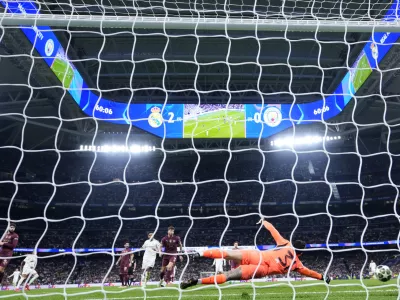 Manchester City's goalkeeper Ederson fails to make a save against a shot by Real Madrid's Kylian Mbappe during the Champions League playoff second leg soccer match between Real Madrid and Manchester City at the Santiago Bernabeu Stadium in Madrid, Spain, Wednesday, Feb. 19, 2025. (AP Photo/Manu Fernandez)