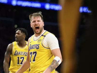 Los Angeles Lakers guard Luka Doncic (77) reacts after making a shot during the second half of an NBA basketball game against the Charlotte Hornets, Wednesday, Feb. 19, 2025, in Los Angeles. (AP Photo/William Liang)